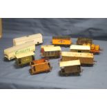 TWELVE CARRIAGES AND ROLLING STOCK, to include tin plate and plastic examples (Boxes and trays not