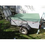 A SMALL CAMPING TRAILER WITH COVER