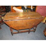 AN ANTIQUE OAK DROPLEAF TABLE