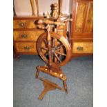 A REPRODUCTION OAK SPINNING WHEEL