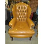 AN ANTIQUE STYLE BROWN LEATHER WINGBACK ARMCHAIR