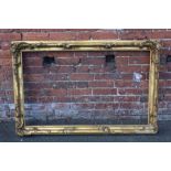 A 19TH CENTURY GILT RECTANGULAR FRAME, with floral detail and acanthus moulded detail, rebate 71 x