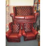 A VINTAGE OXBLOOD CHESTERFIELD STYLE THREE PIECE SUITE