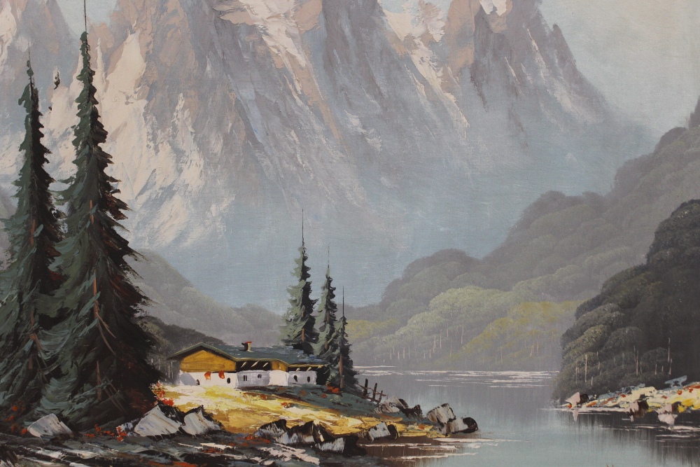 A FRAMED OIL ON CANVAS OF A MOUNTAINOUS LAKE SCENE, SIGNED LOWER LEFT - H 60 CM W 90 CM