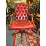 AN OXBLOOD RED SWIVEL OFFICE CHAIR A/F