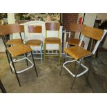 A HARLEQUIN SET OF SIX INDUSTRIAL STYLE METAL BAR STOOLS