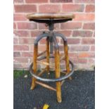 AN INDUSTRIAL STYLE WOOD AND CAST STOOL
