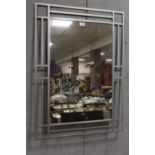 A METAL FRAMED MIRROR - OVERALL H 95.5 CM