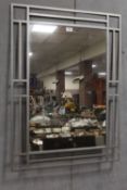 A METAL FRAMED MIRROR - OVERALL H 95.5 CM