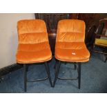 A PAIR OF MODERN BURNT ORANGE KITCHEN STOOLS