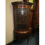 A QUALITY REPRODUCTION MAHOGANY BOWED FLOORSTANDING CORNER CABINET