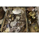 A TRAY OF ASSORTED METALWARE TO INCLUDE FLATWARE, PLACEMATS AND COASTERS, CANDLESTICKS TOGETHER WITH