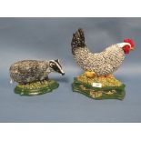 A PAIR OF MODERN CAST DOOR STOPS - A COCKEREL AND A BADGER (2)