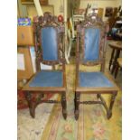 A PAIR OF CARVED OAK JACOBEAN STYLE CHAIRS