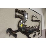 A FRAME MOUNTED METAL CUTTING OF A DRAGON SIGNED NEIL GOW LOWER RIGHT - OVERALL W 93 CM H 48 CM