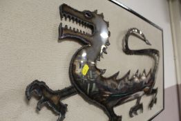 A FRAME MOUNTED METAL CUTTING OF A DRAGON SIGNED NEIL GOW LOWER RIGHT - OVERALL W 93 CM H 48 CM