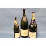 A COLLECTION OF THREE ASSORTED SIZE EMPTY CHAMPAGNE DISPLAY / ADVERTISING BOTTLES
