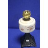 A VINTAGE PARAFFIN LAMP WITH METAL BASE