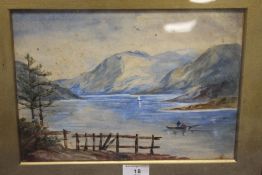 A FRAMED AND GLAZED WATERCOLOUR OF A LAKESIDE SCENE