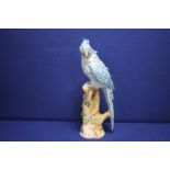 A CERAMIC FIGURE OF A COCKATOO