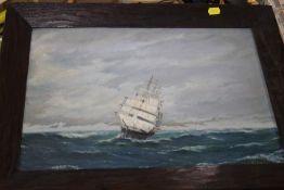 A FRAMED OIL ON CANVAS OF A SHIP AT SEA