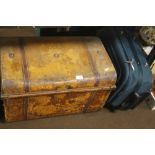 A TIN TRUNK AND A MODERN SUITCASE