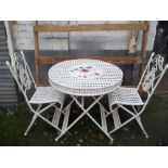 A IRON GARDEN SET INCLUDING A TABLE AND 2 CHAIRS