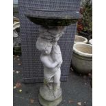 A CONCRETE BIRD BATH, PLANTER DEPICTING A BOY HOLDING A FISH