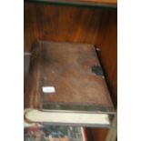 AN ANTIQUE LEATHER BOUND LEDGER WITH BRASS LOCK