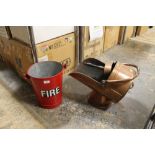 A RED PAINTED GALVANISED FIRE BUCKET TOGETHER WITH A HELMET SHAPED COAL BUCKET AND SHOVEL