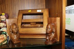 A CARVED WOODEN FOLDING BOOK STAND TOGETHER WITH A PAIR OF CARVED WOODEN AFRICAN BOOK ENDS