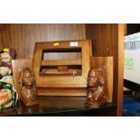 A CARVED WOODEN FOLDING BOOK STAND TOGETHER WITH A PAIR OF CARVED WOODEN AFRICAN BOOK ENDS