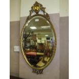 A DECORATIVE GILT OVAL WALL MIRROR H-88 CM