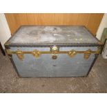 A VINTAGE METAL PACKING TRUNK WITH HANDLES