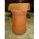 A TERRACOTTA CHIMNEY POT WITH COWELL