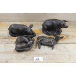 A COLLECTION OF FOUR BRONZE EFFECT PIGS