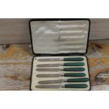 A BOX OF GREEN HANDLED STERLING SILVER KNIVES