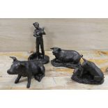 A BRONZE EFFECT MODEL OF A BOY AND HIS PIGLETS TOGETHER WITH THREE OTHER PIG MODELS (4)