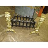 A PAIR OF LARGE BRASS AND CAST LION FIRE DOGS WITH A FIRE GRATE