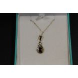 A 9CT GOLD GEMSET PENDANT AND CHAIN STAMPED 375