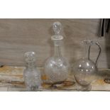A CUT GLASS BANDED NECK DECANTER AND ANOTHER TOGETHER WITH A GLASS EWER (3)