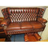 AN OXBLOOD RED LEATHER THREE SEATER SETTEE AND ARMCHAIR (2)