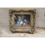 A GILT FRAMED PORCELAIN PLAQUE DEPICTING A CAT WITH KITTENS BY A VASE OF FLOWERS SIGNED LOWER
