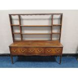 A GEORGIAN OAK DRESSER, with later open rack, three drawers to the base, with crossbanded detail,