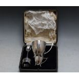 A CASED HALLMARKED SILVER MATCHED BREAKFAST SET, consisting of an Arts and Crafts style cup and