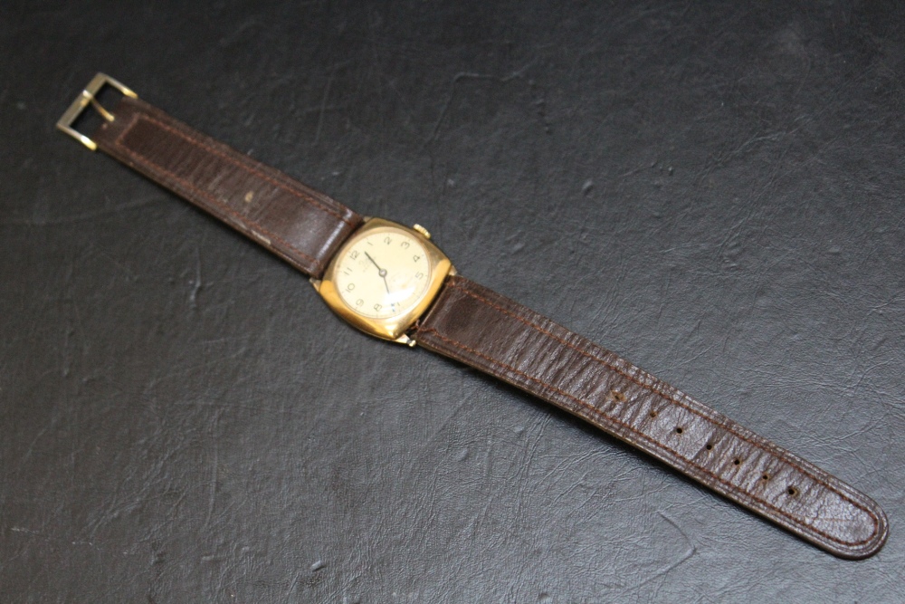A RECORD 9CT GOLD WRIST WATCH, on leather strap, with presentation engraving to reverse, Dia 3