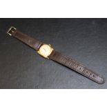 A RECORD 9CT GOLD WRIST WATCH, on leather strap, with presentation engraving to reverse, Dia 3