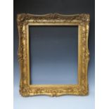 A 19TH CENTURY DECORATIVE GOLD SWEPT FRAME, frame W 9 cm, rebate 62 x 51 cm