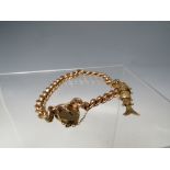 A HALLMARKED 9CT GOLD CHARM BRACELET, with single 9ct gold hallmarked charm attached, the shaped