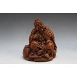 AN ORIENTAL BAMBOO CARVING OF A CHINESE FISHERMAN, H 16 cm